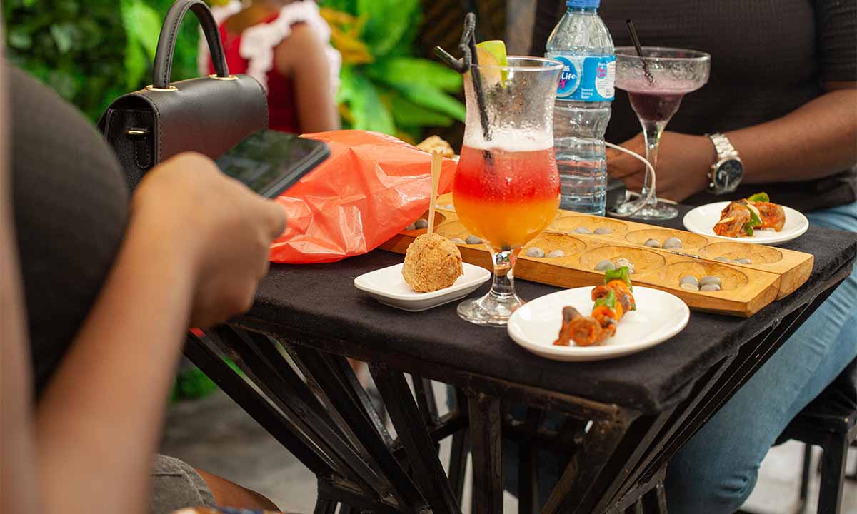 Cocktails and food with water on a table