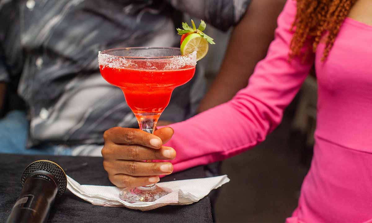 lady holding a pink cocktail